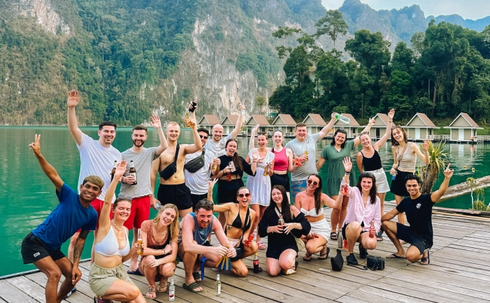 Thailand expedition group on dock with floating bungalows