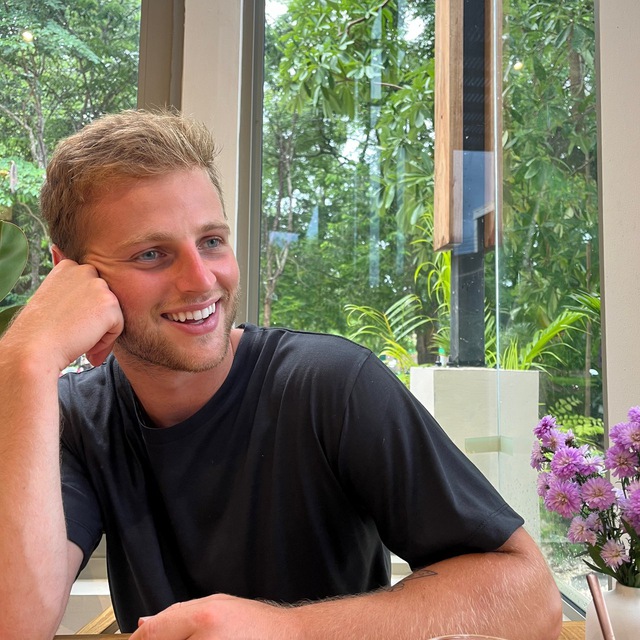 Jack Moses smiling in a tropical setting